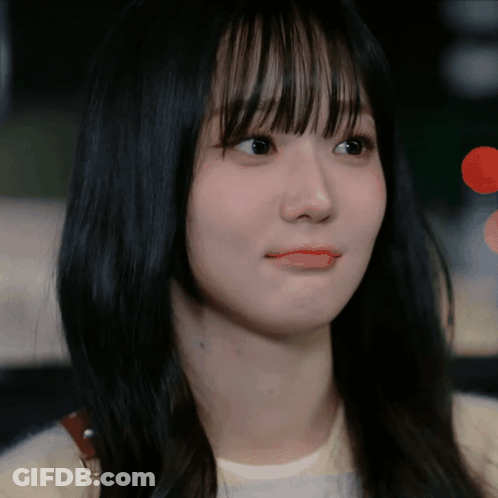 A Close Up Of A Woman 'S Face With Long Black Hair GIF
