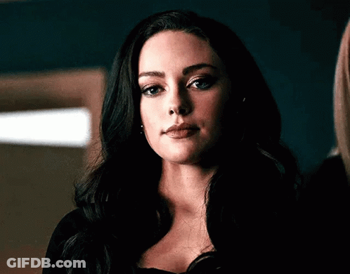 A Close Up Of A Woman 'S Face With Long Black Hair . GIF