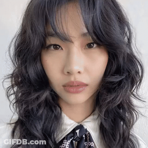 A Close Up Of A Woman 'S Face With Long Black Hair GIF