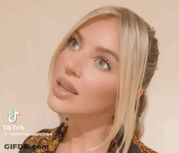 A Close Up Of A Woman 'S Face With Long Blonde Hair . GIF