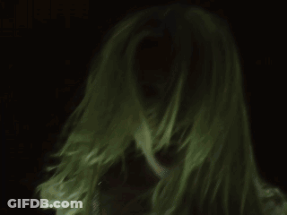 A Close Up Of A Woman 'S Face With Long Blonde Hair GIF