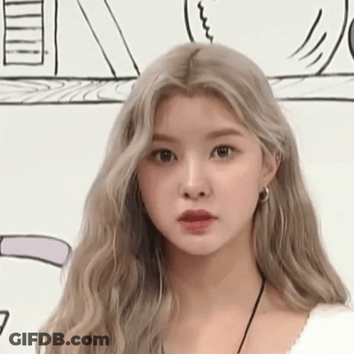 A Close Up Of A Woman 'S Face With Long Blonde Hair Against A White Background . GIF