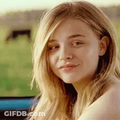 A Close Up Of A Woman 'S Face With Long Blonde Hair . GIF