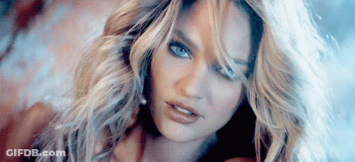 A Close Up Of A Woman 'S Face With Long Blonde Hair GIF