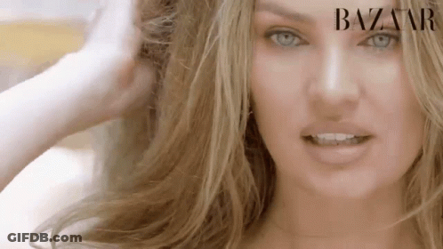 A Close Up Of A Woman 'S Face With Long Blonde Hair . GIF