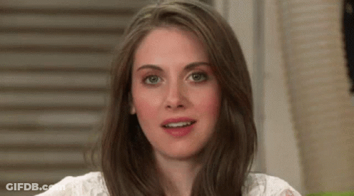 A Close Up Of A Woman 'S Face With Long Brown Hair And A White Shirt . GIF