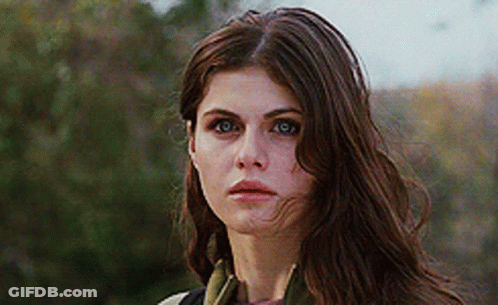 A Close Up Of A Woman 'S Face With Long Brown Hair GIF