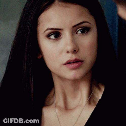 A Close Up Of A Woman 'S Face With Long Dark Hair GIF