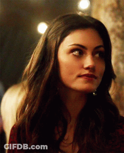 A Close Up Of A Woman 'S Face With Long Dark Hair GIF