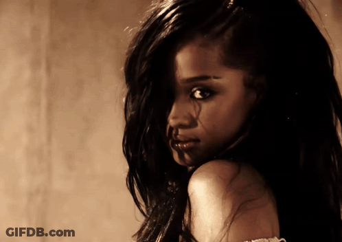 A Close Up Of A Woman 'S Face With Long Dark Hair GIF