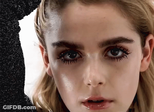 A Close Up Of A Woman 'S Face With Long Eyelashes GIF