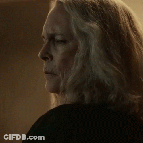 A Close Up Of A Woman 'S Face With Long Grey Hair GIF