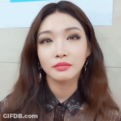 A Close Up Of A Woman 'S Face With Long Hair GIF