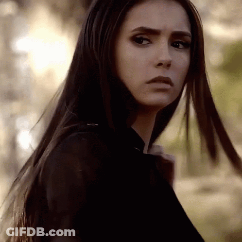 A Close Up Of A Woman 'S Face With Long Hair . GIF