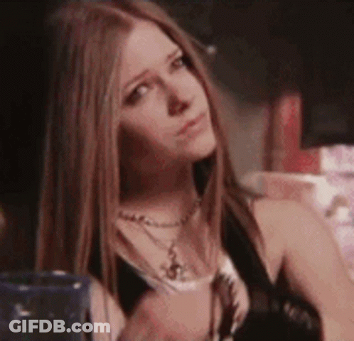 A Close Up Of A Woman 'S Face With Long Hair . GIF