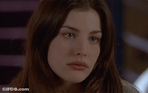 A Close Up Of A Woman 'S Face With Long Hair GIF