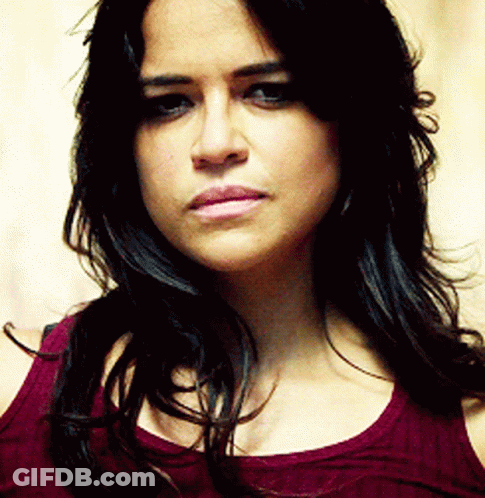 A Close Up Of A Woman 'S Face With Long Hair GIF