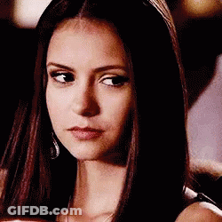 A Close Up Of A Woman 'S Face With Long Hair And A Serious Look On Her Face . GIF