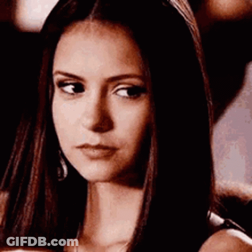 A Close Up Of A Woman 'S Face With Long Hair And A Serious Look On Her Face . GIF