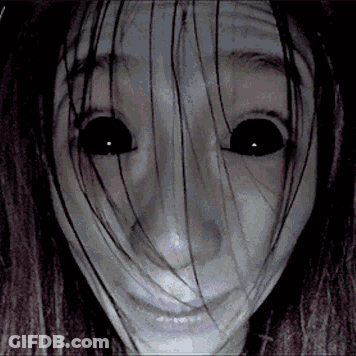 A Close Up Of A Woman 'S Face With Long Hair And Black Eyes . GIF