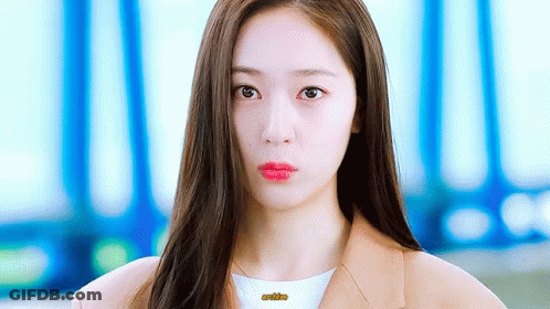 A Close Up Of A Woman 'S Face With Long Hair And Red Lips GIF