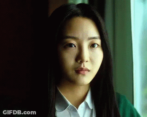 A Close Up Of A Woman 'S Face With Long Hair GIF