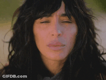 A Close Up Of A Woman 'S Face With Long Hair GIF