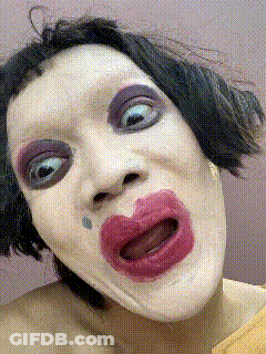 A Close Up Of A Woman 'S Face With Makeup On GIF