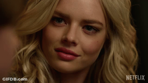 A Close Up Of A Woman 'S Face With Netflix Written On The Bottom GIF
