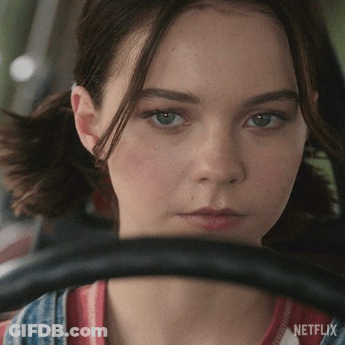 A Close Up Of A Woman 'S Face With Netflix Written On The Bottom Right GIF