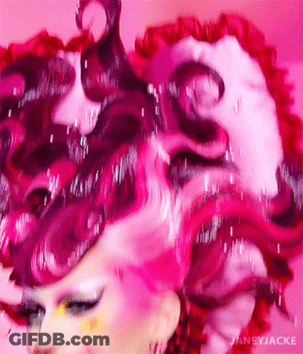 A Close Up Of A Woman 'S Face With Pink Hair GIF
