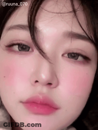 A Close Up Of A Woman 'S Face With Pink Lips GIF