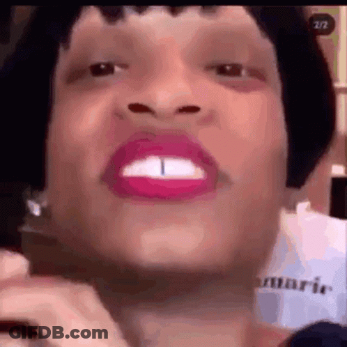 A Close Up Of A Woman 'S Face With Pink Lipstick And A Very Large Mouth . GIF