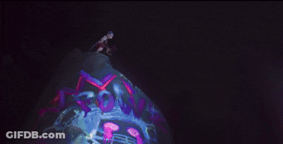 A Close Up Of A Woman 'S Face With Purple Eyes . GIF
