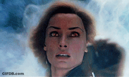 A Close Up Of A Woman 'S Face With Red Eyes Looking At The Camera GIF