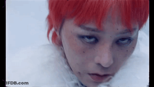 A Close Up Of A Woman 'S Face With Red Hair And Freckles . GIF