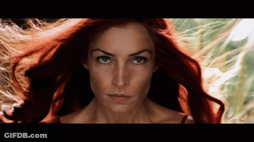 A Close Up Of A Woman 'S Face With Red Hair GIF