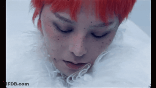 A Close Up Of A Woman 'S Face With Red Hair GIF