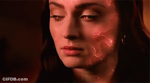 A Close Up Of A Woman 'S Face With Red Lightning Bolts Coming Out Of It . GIF