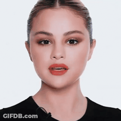 A Close Up Of A Woman 'S Face With Red Lips And A Microphone . GIF