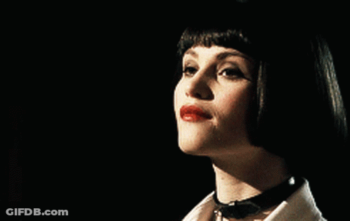 A Close Up Of A Woman 'S Face With Red Lips GIF