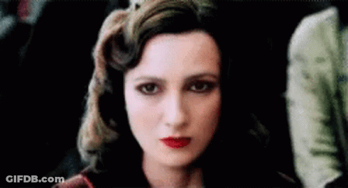 A Close Up Of A Woman 'S Face With Red Lips . GIF