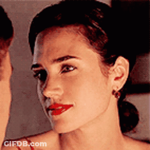 A Close Up Of A Woman 'S Face With Red Lipstick . GIF