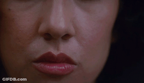 A Close Up Of A Woman 'S Face With Red Lipstick GIF