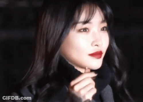 A Close Up Of A Woman 'S Face With Red Lipstick . GIF