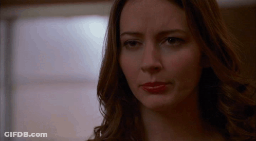 A Close Up Of A Woman 'S Face With Red Lipstick On Her Lips . GIF
