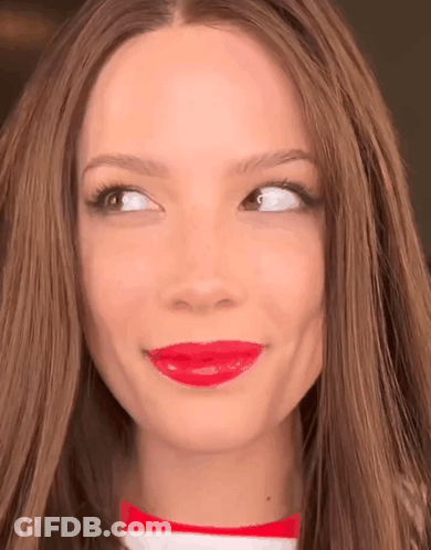 A Close Up Of A Woman 'S Face With Red Lipstick On Her Lips GIF