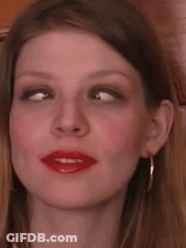 A Close Up Of A Woman 'S Face With Red Lipstick On . GIF