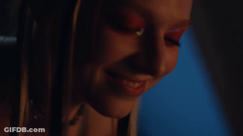 A Close Up Of A Woman 'S Face With Red Makeup GIF
