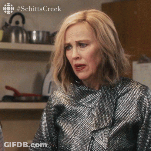 A Close Up Of A Woman 'S Face With #Schitts Creek On The Bottom Right GIF